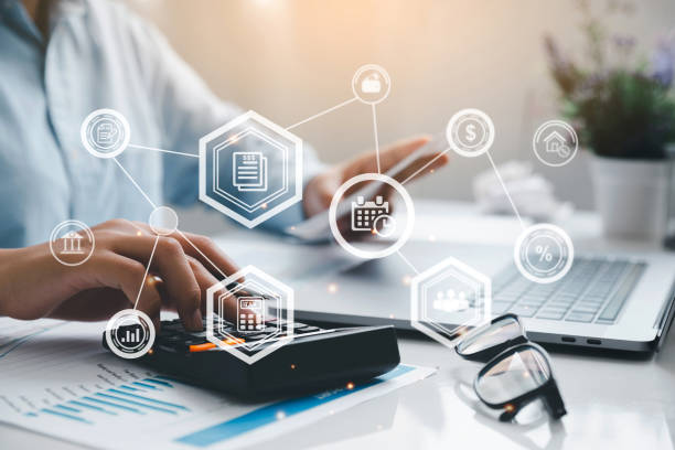 istockphoto Man hand using a calculator and fill in the income tax online return form for payment. Financial research, government taxes, and calculation tax return concept.Tax and Vat concept.